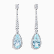 Elegant 14K white gold linear drop earrings featuring teardrop-shaped aquamarine gemstones, accented with diamonds.