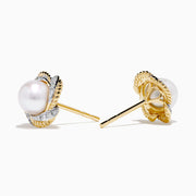 A pair of 14K yellow gold scalloped edge stud earrings featuring a central freshwater pearl, accented with diamonds, set against a white background.