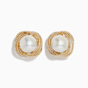 The 14K Yellow Gold Diamond Fresh Water Pearl Earrings showcase large freshwater pearls at the center, framed by sparkling diamonds in an elegant wavy square design, set against a white background.