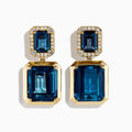 14K Yellow Gold Emerald-Cut Blue Topaz and Diamond Drop Earrings feature large rectangular blue topaz stones topped with smaller gems, both outlined by sparkling clear diamonds, displayed on a white background.