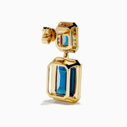 14K Yellow Gold Emerald-Cut Blue Topaz and Diamond Drop Earrings feature large rectangular blue topaz stones topped with smaller gems, both outlined by sparkling clear diamonds, displayed on a white background.