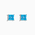 The Ocean Bleu 14K White Gold Blue Topaz Stud Earrings feature square-cut blue topaz in four-prong settings, displayed on a white background.