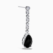 A pair of 14K White Gold Black Onyx and Diamond Linear Drop Earrings featuring alternating diamonds and black onyx gemstones, ending with a large faceted teardrop-shaped black onyx for a timeless look.
