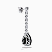 A pair of 14K White Gold Black Onyx and Diamond Linear Drop Earrings featuring alternating diamonds and black onyx gemstones, ending with a large faceted teardrop-shaped black onyx for a timeless look.