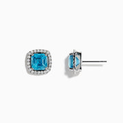 14K White Gold Blue Zircon and Diamond Stud Earrings featuring square-cut blue zircon stones, each encircled by a halo of sparkling diamonds, set on a white background.