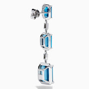 14K White Gold Blue Topaz and Diamond Linear Drop Earrings featuring three rectangular blue topaz gems and two small vertical diamonds in an alternating, linear pattern.