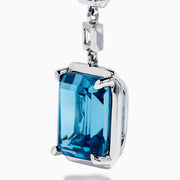 14K White Gold Blue Topaz and Diamond Linear Drop Earrings featuring three rectangular blue topaz gems and two small vertical diamonds in an alternating, linear pattern.