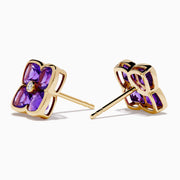 14K Yellow Gold Amethyst and Diamond Earrings featuring four-petaled flower shapes with vivid amethyst petals and a central round diamond, shown on a white background—ideal as elegant statement earrings.