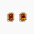 The 14K Yellow Gold Citrine and Diamond Halo Earrings feature rectangular emerald-cut citrine stones encircled by a diamond halo, displayed on a plain white background.