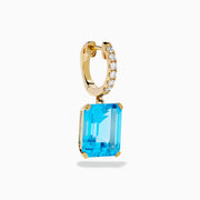 The 14K Yellow Gold Blue Topaz and Diamond Dangle Earrings feature large emerald-cut blue topaz gemstones and small round diamonds, displayed elegantly on a white background.