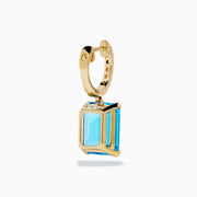 The 14K Yellow Gold Blue Topaz and Diamond Dangle Earrings feature large emerald-cut blue topaz gemstones and small round diamonds, displayed elegantly on a white background.