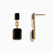 The Eclipse 14K Yellow Gold Onyx and Diamond Bezel Drop Earrings feature black rectangular onyx stones at the top and bottom, separated by a small clear diamond in the center.