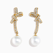 14K Yellow Gold Diamond Bow and Cultured Pearl Linear Drop Earrings, featuring diamond-studded bows and dangling cultured pearls, shown on a white background.
