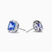 The Effy Hematian 18K White Gold Tanzanite and Diamond Cushion Halo Stud Earrings feature vibrant deep blue cushion-cut tanzanites, each encircled by a halo of sparkling white diamonds.