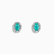 The Effy Hematian 14K White Gold Paraiba and Diamond Halo Stud Earrings feature vibrant green-blue Paraiba gemstones, each surrounded by a halo of sparkling diamonds in an elegant oval-shaped design.