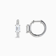 Lab Grown Diamond Emerald-Cut Huggie Earrings in 14K White Gold showcase rectangular center stones accented by small round diamonds, elegantly set and displayed against a plain white background.