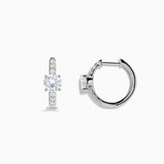 Lab Grown Diamond Round Huggie Earrings in 14K White Gold, featuring a central round diamond with vertical rows of smaller diamonds, displayed on a plain white background.
