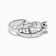 Lab Grown Diamond Round Huggie Earrings in 14K White Gold, featuring a central round diamond with vertical rows of smaller diamonds, displayed on a plain white background.