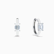 A pair of Lab Grown Diamond Emerald-Cut Huggie Earrings in 14K White Gold, each featuring a vertically set emerald-cut lab diamond at the front, displayed against a plain white background.