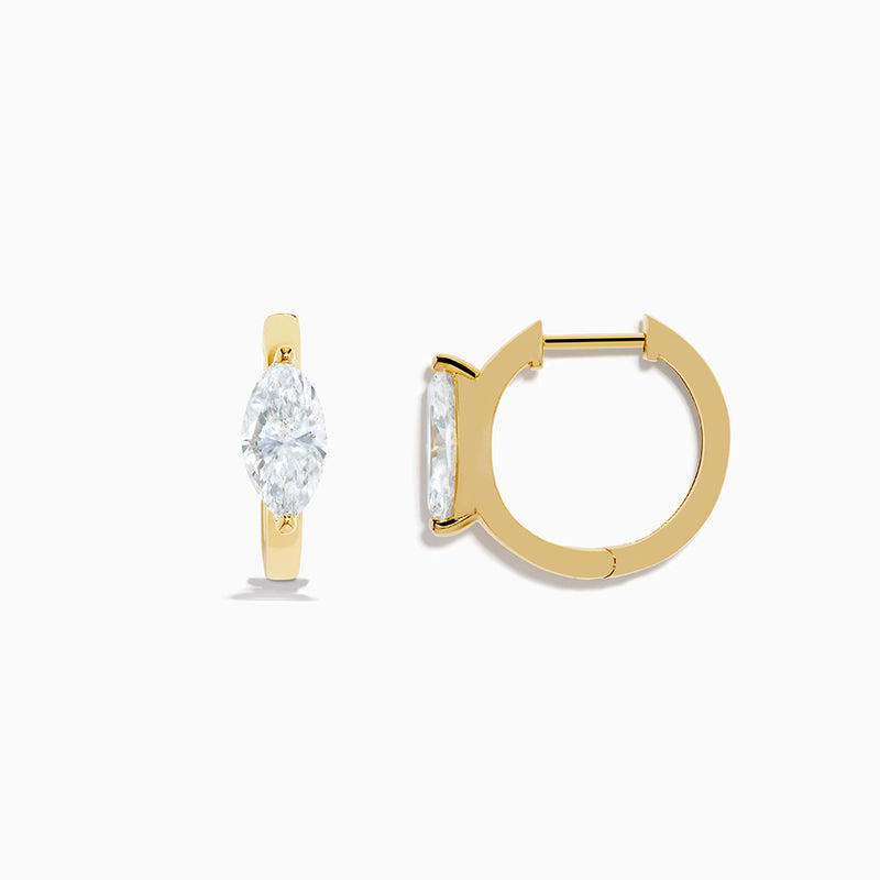 A pair of Lab Grown Diamond Marquise Huggie Earrings in 14K yellow gold, each with sparkling diamonds, shown against a plain white background.