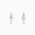 A pair of Lab Grown Diamond Oval Huggie Earrings in 14K white gold, each adorned with sparkling diamonds in a sleek, modern setting, displayed on a plain white background.