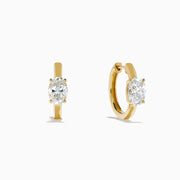 Lab Grown Diamond Oval Huggie Earrings in 14K Yellow Gold, each featuring a single oval lab grown diamond, displayed on a plain white background.