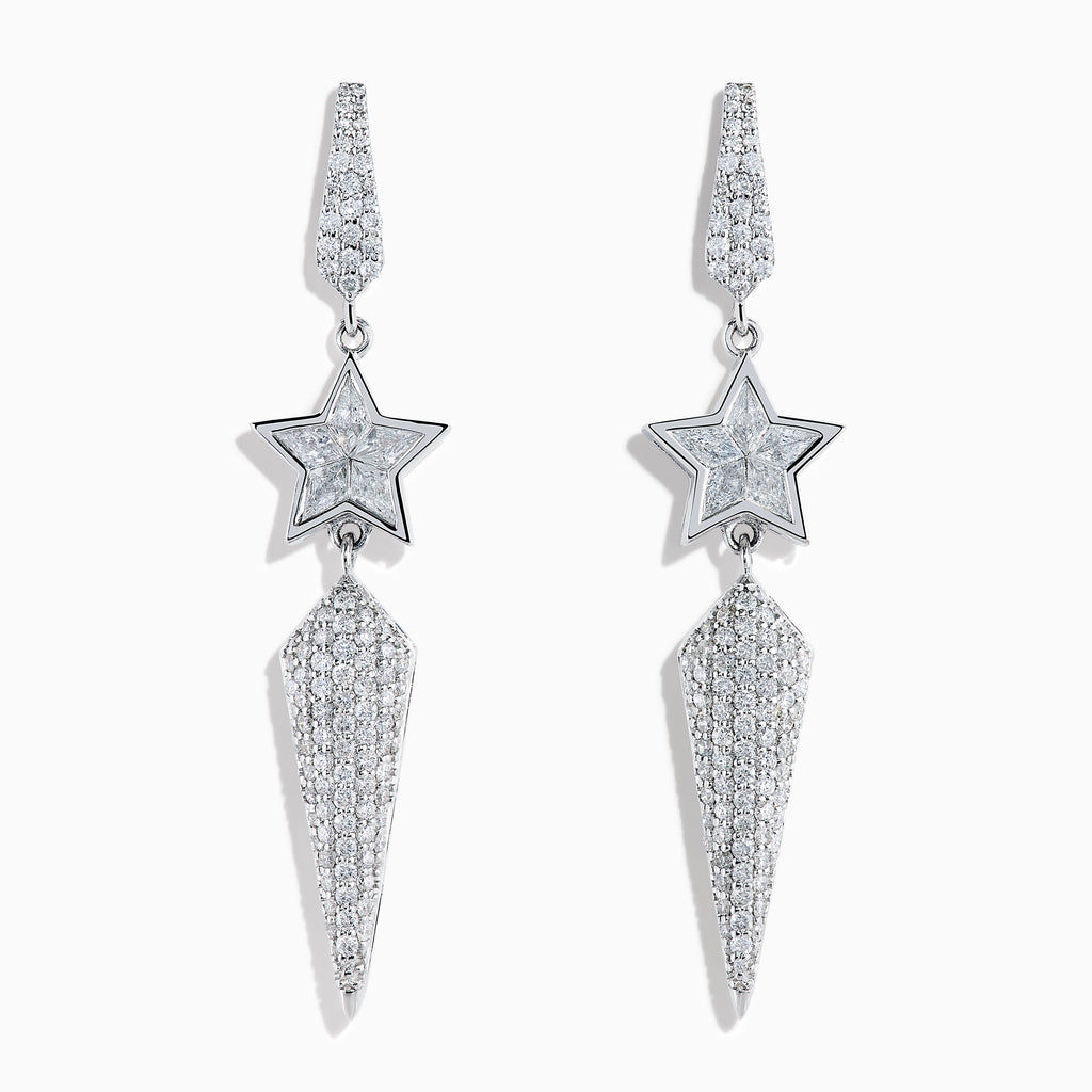 The 18K White Gold Diamond Shooting Star Linear Drop Earrings showcase a central star design with a long, pointed diamond-encrusted dangle, displayed on a plain white background.