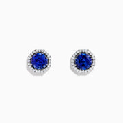 The Nahla Siri 14K Gold Octagon Cut Tanzanite and Diamond Earrings feature octagonal tanzanite gemstones encircled by small clear diamonds, set against a plain white background.