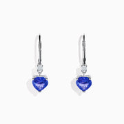 The Nahla Siri 14K White Gold Tanzanite and Diamond Leverback Earrings feature heart-shaped blue tanzanite stones accented with sparkling diamonds, shown on a white background.