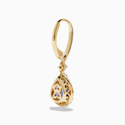 The Nahla 14K Yellow Gold Tanzanite and Diamond Dangle Halo Earrings showcase teardrop tanzanites encircled by diamonds, with extra diamonds on the hooks, all set against a white background.