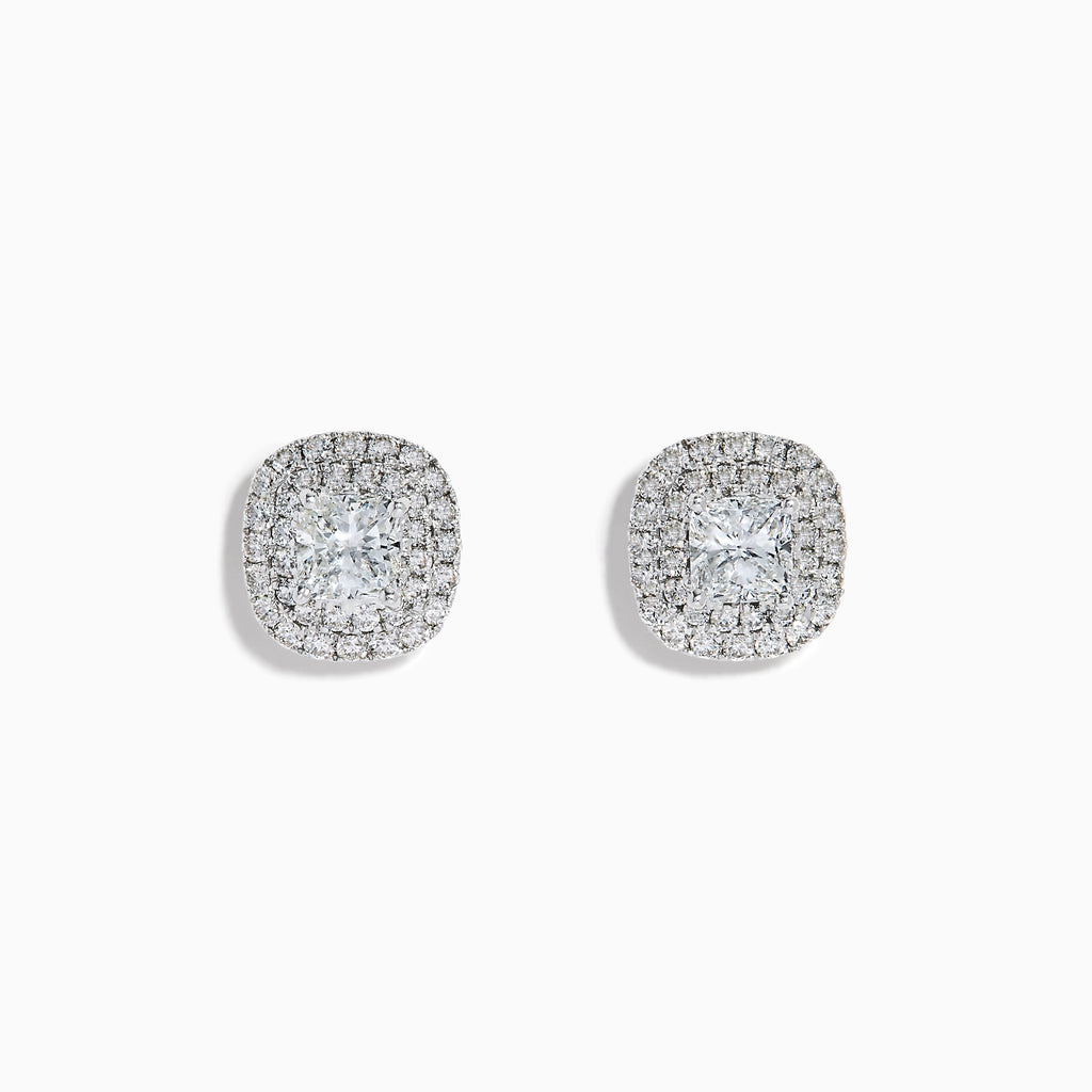 The 18K White Gold Diamond Double Halo Cushion Stud Earrings feature cushion-cut diamonds surrounded by double halos of smaller diamonds, set in 18K white gold and displayed on a white background.