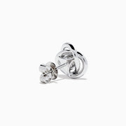 The 18K White Gold Diamond Love Knot Stud Earrings feature interlocking loops with sparkling diamonds and a central pear-shaped diamond, all set in elegant white gold against a plain white background.