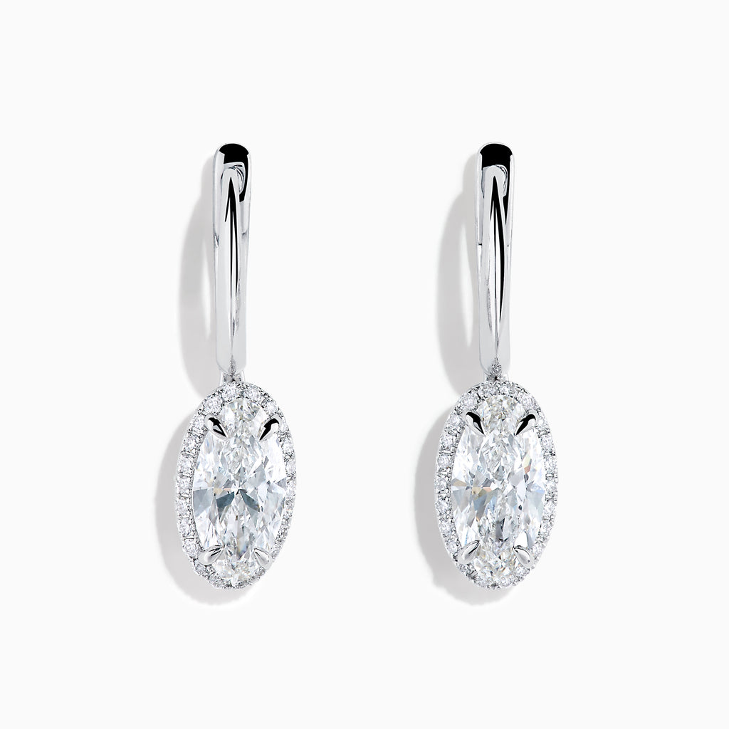 The Lab Grown Diamond Elongated Oval Drop Earrings in 14K White Gold feature clear gemstones surrounded by lab grown diamonds, set in polished white gold with a simple hook design, displayed against a white background.