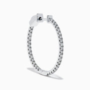 The Pave Classica 14K White Gold Diamond Hoop Earrings, encrusted with sparkling diamonds, are shown against a white background with soft shadows cast to the left.