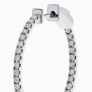 The Pave Classica 14K White Gold Diamond Hoop Earrings, encrusted with sparkling diamonds, are shown against a white background with soft shadows cast to the left.
