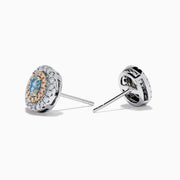 The 18K Two Tone Gold Certified Natural Blue and White Diamond Stud Earrings feature a central blue gemstone framed by two rows of natural diamonds in a circular design with elegant gold details.