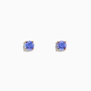 The 14K Yellow Gold Tanzanite Stud Earrings each showcase a round, faceted tanzanite in a four-prong setting, displayed on a white background.