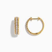 The Duo 14K Two Tone Gold 5/8 Diamond Hoop Earrings feature a twisted rope design and a vertical row of sparkling diamonds at the center.