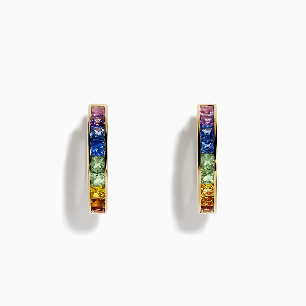 The Watercolor 14k Yellow Gold Princess Cut Multi Sapphire Hoop Earrings feature a rainbow gradient of square-cut sapphires—purple, blue, green, yellow, and orange—set on hoops and shown against a white background.