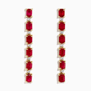 The 14K Yellow Gold Ruby and Diamond Linear Drop Earrings showcase alternating rectangular rubies and small round diamonds arranged vertically for an elegant, modern look.