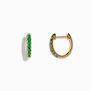 The 14K Yellow Gold Emerald Huggie Earrings feature small gold hoops set with bright green gemstones, crafted in 14K yellow gold and showcased against a white background.