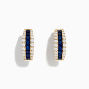 The Royale Bleu 14K Yellow Gold Blue Sapphire and Diamond Hoop Earrings feature a central row of square blue sapphires with round white diamonds on each side, displayed against a plain white background.