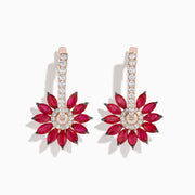 The 14K Rose Gold Ruby and Diamond Floral Huggie Earrings feature marquise-cut rubies as petals, accented by white diamonds and a vertical row of diamonds on elegant rose gold.