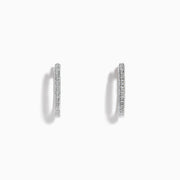 The Pave Classica 14k White Gold Diamond Hoop Earrings feature a thin, sparkling pave surface and are shown against a plain white background.