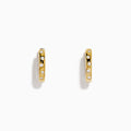 The D'Oro 14K Yellow Gold Diamond Huggie Earrings each feature three round white diamonds set vertically and are displayed against a plain white background.
