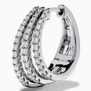 Elegant 14K White Gold Diamond Triple-Band Huggie Hoop Earrings featuring three overlapping curved rows of sparkling diamonds, set against a white background.