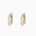 D'Oro 14K Yellow Gold Bezel Set Diamond Mini Hoop Earrings feature round diamonds in bezel settings along the front, alternating with gold, shown on a white background.
