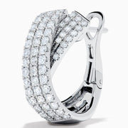 A pair of 14K white gold diamond pave crossover chunky hoop earrings, featuring an X-shaped design encrusted with multiple rows of sparkling diamonds, displayed on a plain white background.