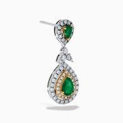 Chic 14K two tone gold statement earrings featuring double pear emeralds, concentric rows of white and yellow diamonds, and a delicate diamond bow—elegant emerald and diamond earrings for any occasion.