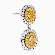 The Canare 18K Two Tone Gold White & Yellow Gold Earrings feature two oval yellow gemstones on each earring, surrounded by small white stones, set in white and yellow gold, displayed against a plain white background.
